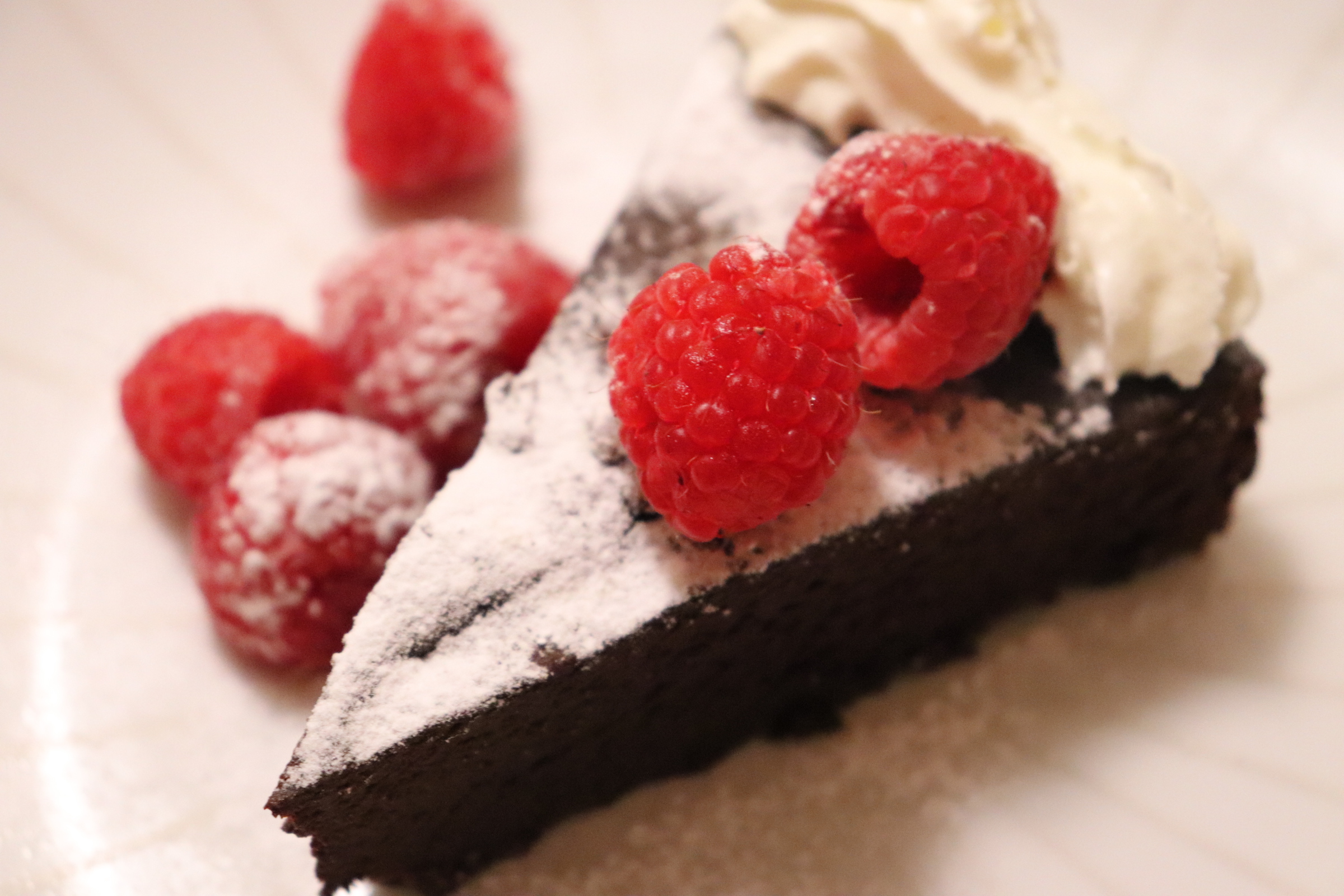 Low Carb Chocolate Torte with Powdered Erythritol and Topped with Raspberries